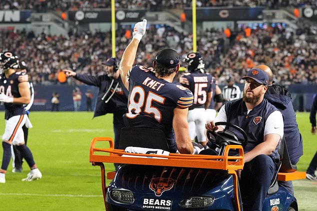 Chicago Bears tight end Cole Kmet (85) gives a thumbs up as he is carted off the field after suffering an injury during the second half of an NFL football game against the New England Patriots in Chicago, Thursday, Oct. 22, 2026. (AP Photo/Nam Y. Huh)