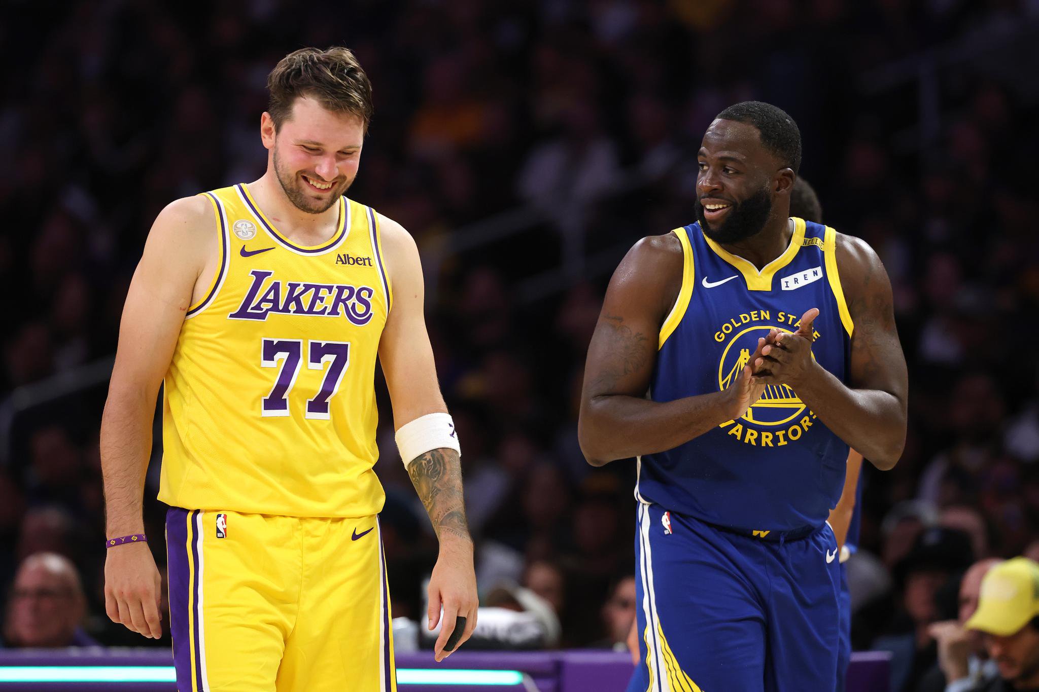 Luka Doncic (77) of the Los Angeles Lakers shares a laugh with Draymond Green (23) of the Golden State Warriors during the second half of an NBA basketball game at Crypto.com Arena on Wednesday, Oct. 21, 2026, in Los Angeles.