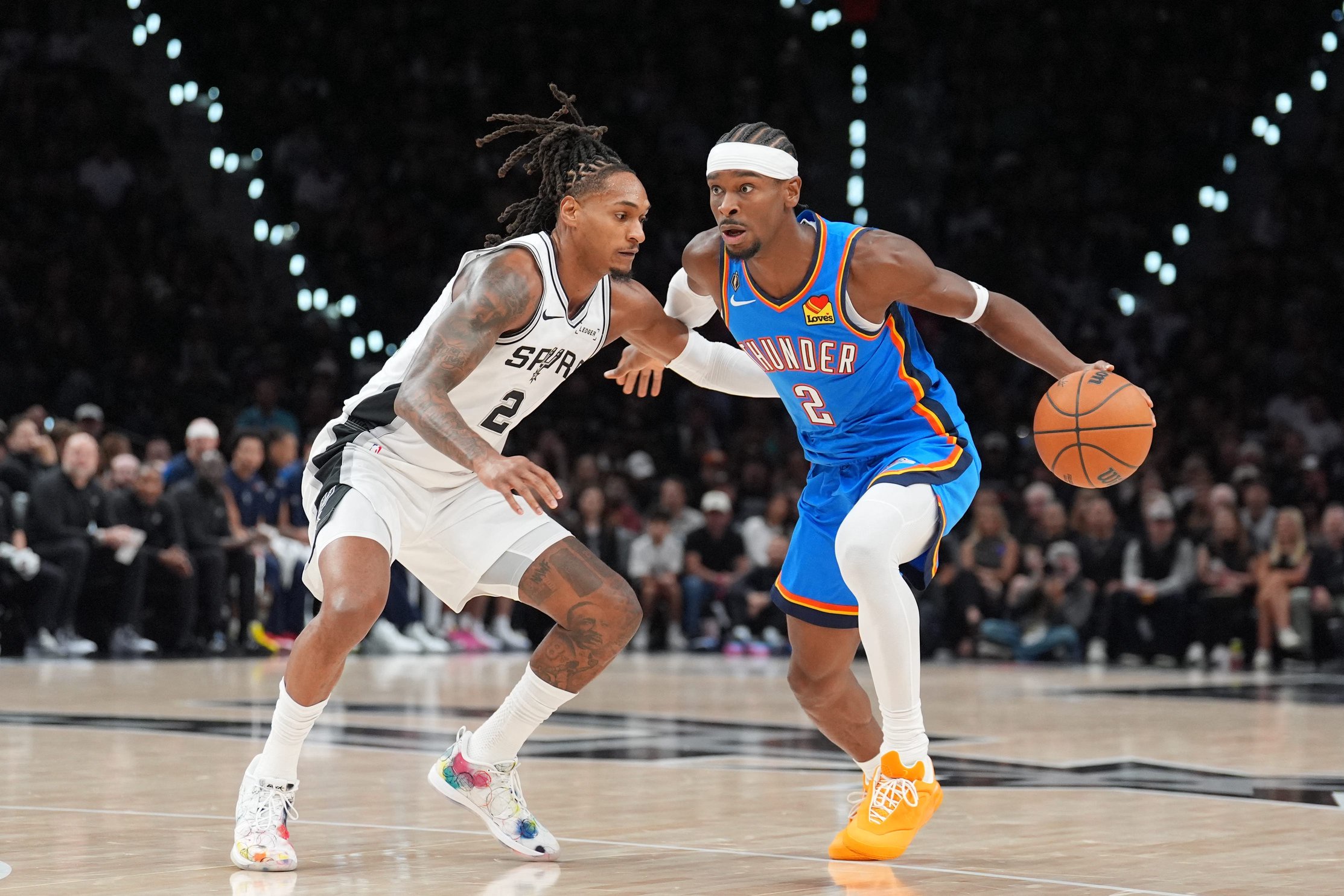 Oct 20, 2026; San Antonio, Texas, USA;  Oklahoma City Thunder guard Shai Gilgeous-Alexander (2) dribbles against San Antonio Spurs guard Devin Vassell (24) in the first half at Frost Bank Center.  Mandatory Credit: Daniel Dunn-Imagn Images