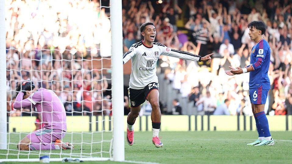 Lisandro Martinez watches the aftermath of his own goal as Fulham's Josh King celebrates