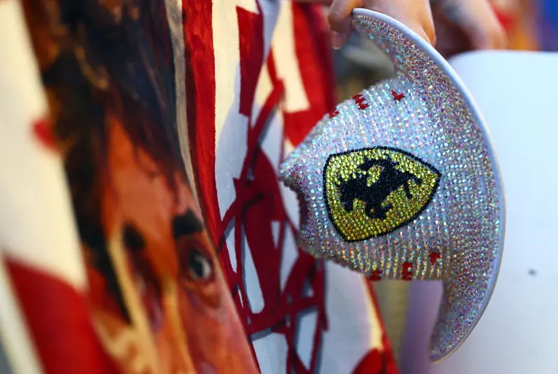 A fan holds a Ferrari cowboy hat covered in rhinestones in Austin