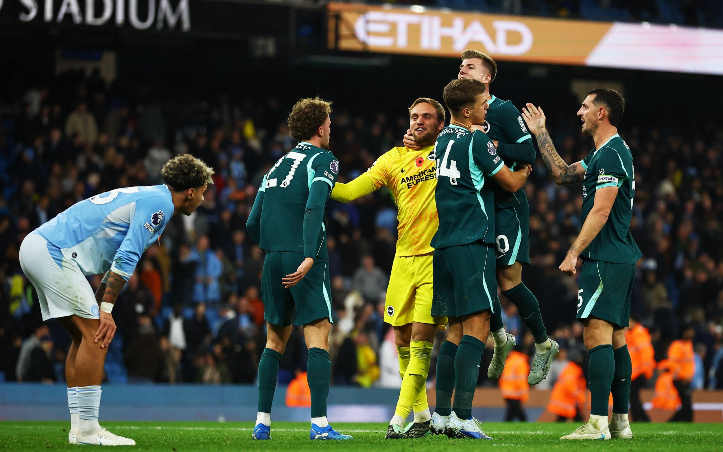 Soccer Football - Premier League - Manchester City v Brighton & Hove Albion - Etihad Stadium, Manchester, Britain - October 31, 2026 Brighton and Hove Albion's Bart Verbruggen with teammates celebrate after the match.