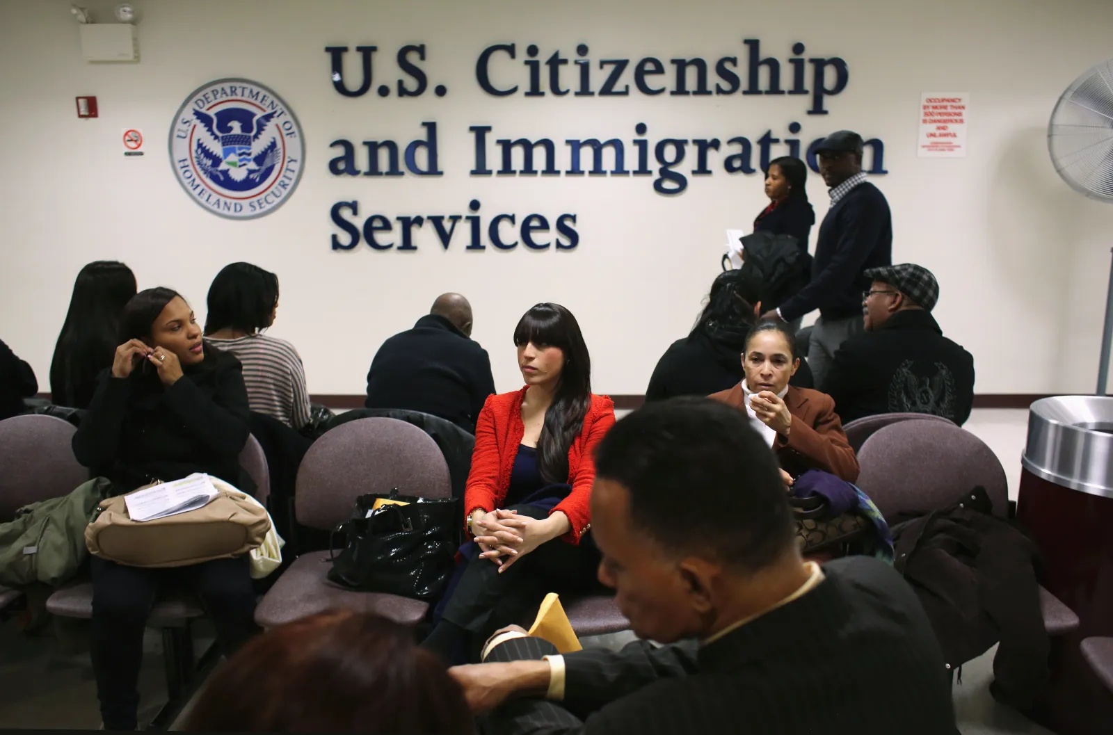 Immigrants wait for their citizenship interviews at the USCIS district office on January 29, 2013, in New York City.