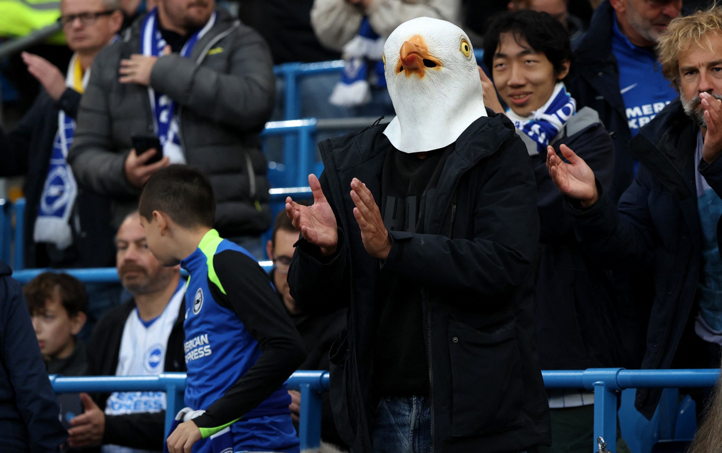 A Brighton supporter wears a seagull mask during the English Premier League football match between Manchester City and Brighton and Hove Albion at the Etihad Stadium in Manchester, north west England, on October 31, 2026.