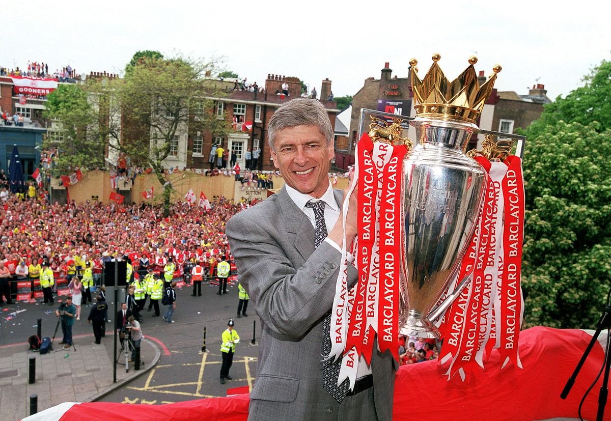 Arsenal manager Arsene Wenger holds the Premier League trophy at Islington Town Hall
