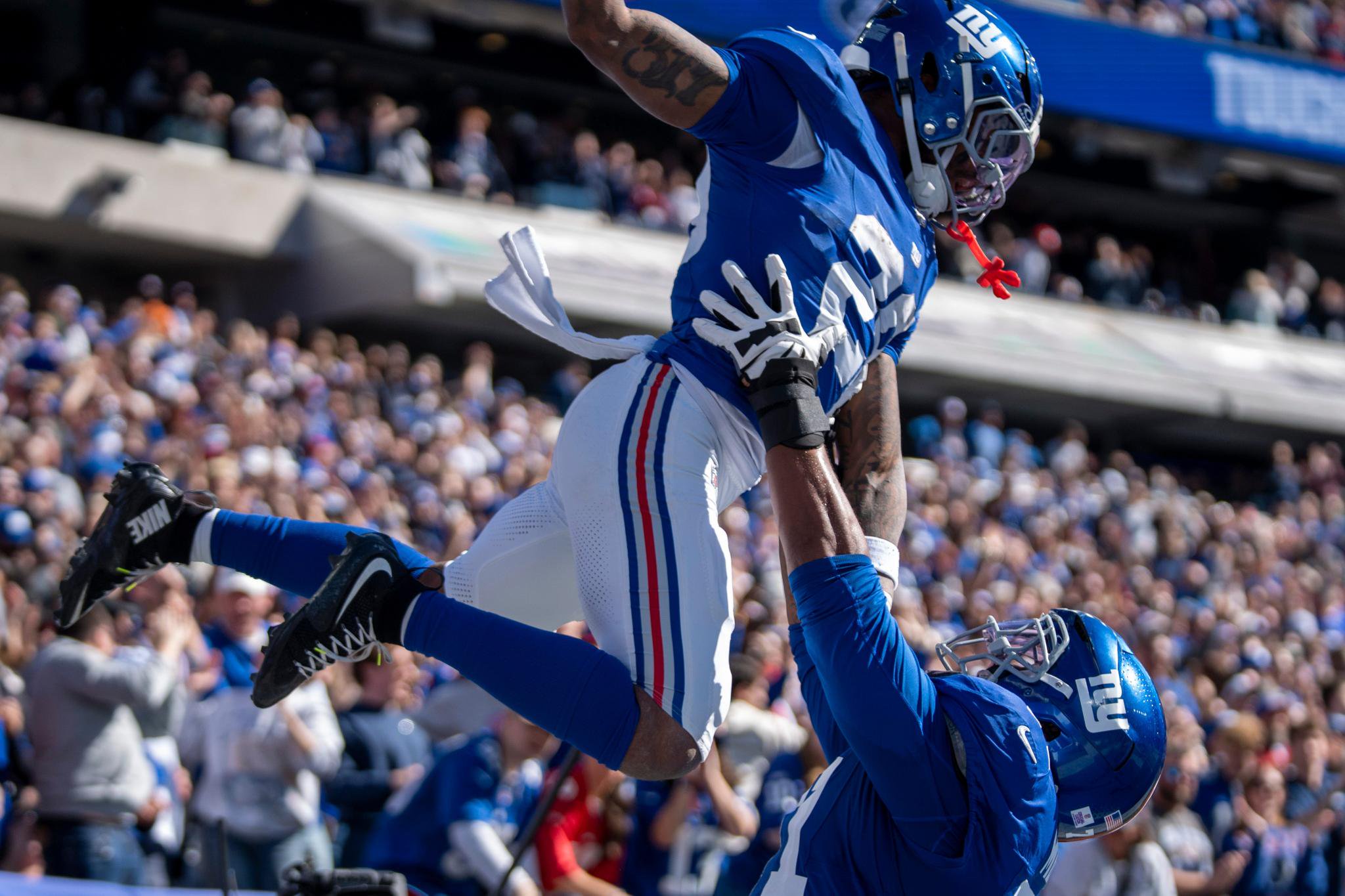 New York Giants running back Tyrone Tracy Jr. celebrates with guard Marcus Mbow after scoring a touchdown.