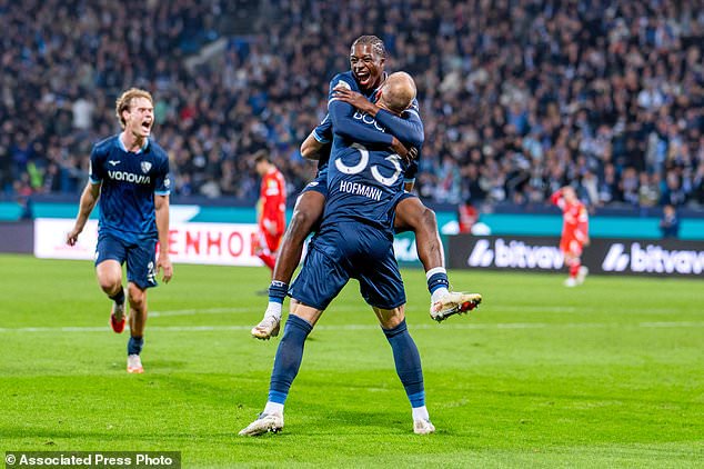 Bochum's Philipp Hofmann, back to the camera, celebrates with Mansour Ouro-Tagba after scoring his side's second goal during the German soccer cup match between VfL Bochum and FSV Mainz 05 in Bochum, Germany, Tuesday, Oct. 27, 2026. (David Inderlied/dpa via AP)
