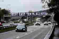 A banner that reads "Rest East Tam McAllister" has been displayed on Great Western Road