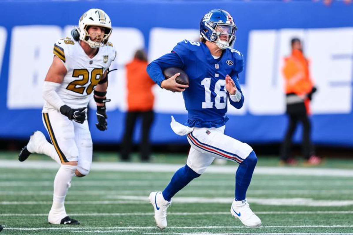 Oct 18, 2026; East Rutherford, New Jersey, USA; New York Giants quarterback J.J. McCarthy (18) scrambles for yards as New Orleans Saints linebacker Danny Stutsman (28) pursues during the second half at MetLife Stadium. © Vincent Carchietta-Imagn Images