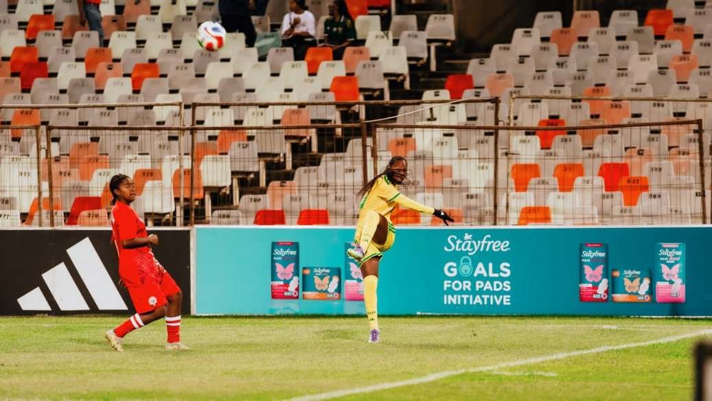 Banyana Banyana goalkeeper kicks a ball past a Stayfree Goals for Pads Initiative board at the stadium.