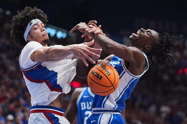 Kansas' Tyran Stokes, left, and Duke's Dame Sarr battle for the ball during the second half of an exhibition NCAA college basketball game Sunday, Oct. 25, 2026, in Lawrence, Kan. (AP Photo/Charlie Riedel)