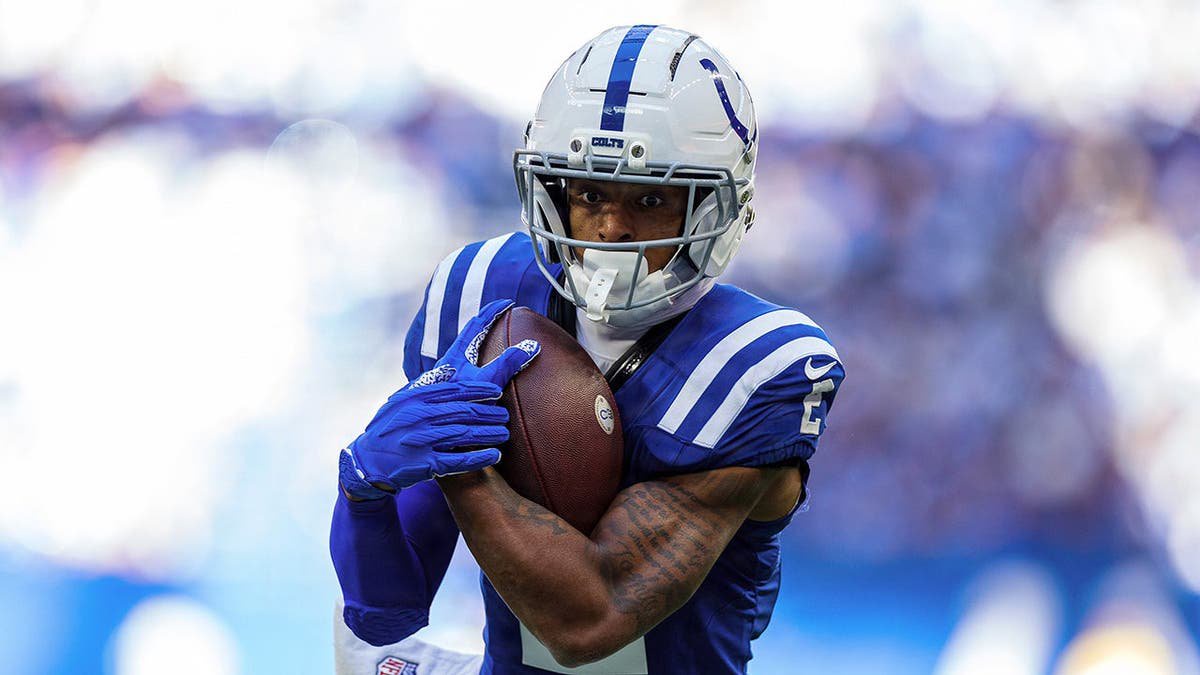 Josh Downs runs with the ball during NFL game action against the Tennessee Titans.