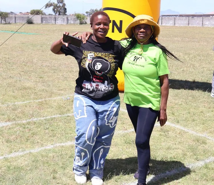 Nomalanga Magona celebrates her win with another resident on Friday. Photos: Mary-Anne Gontsana/@GroundUp