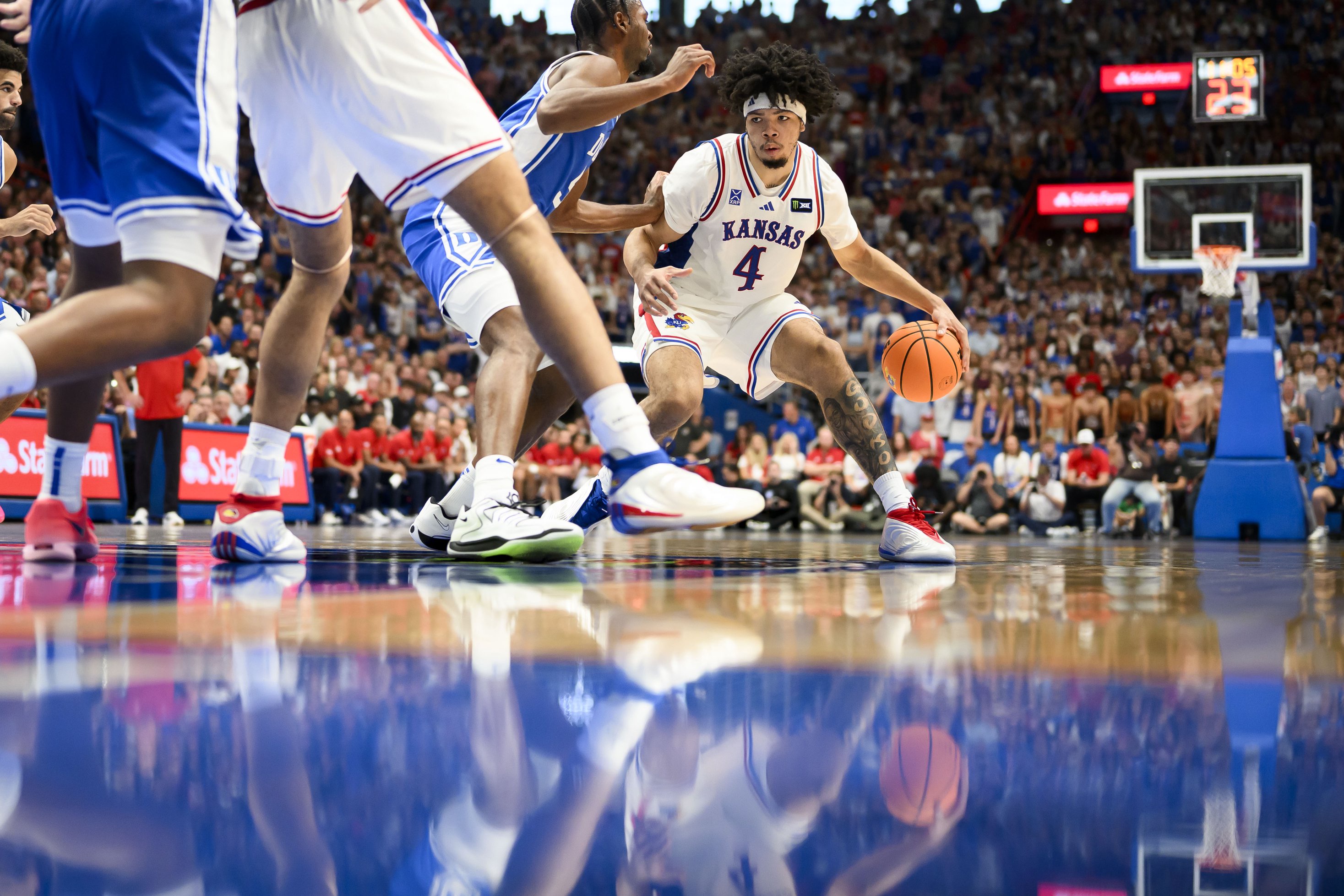 LAWRENCE, KANSAS - OCTOBER 25: Tyran Stokes #4 of the Kansas Jayhawks is guarded by Sebastian Wilkins #5 during the first half of an exhibition game at Allen Fieldhouse on October 25, 2026 in Lawrence, Kansas. (Photo by Reed Hoffmann/Getty Images)