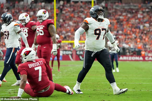 Denver Broncos defensive tackle Malcolm Roach (97) reacts to a hit on Arizona Cardinals quarterback Jacoby Brissett (7) during the first half of an NFL football game in Glendale, Ariz., Sunday, Oct. 25, 2026. (AP Photo/Rick Scuteri)