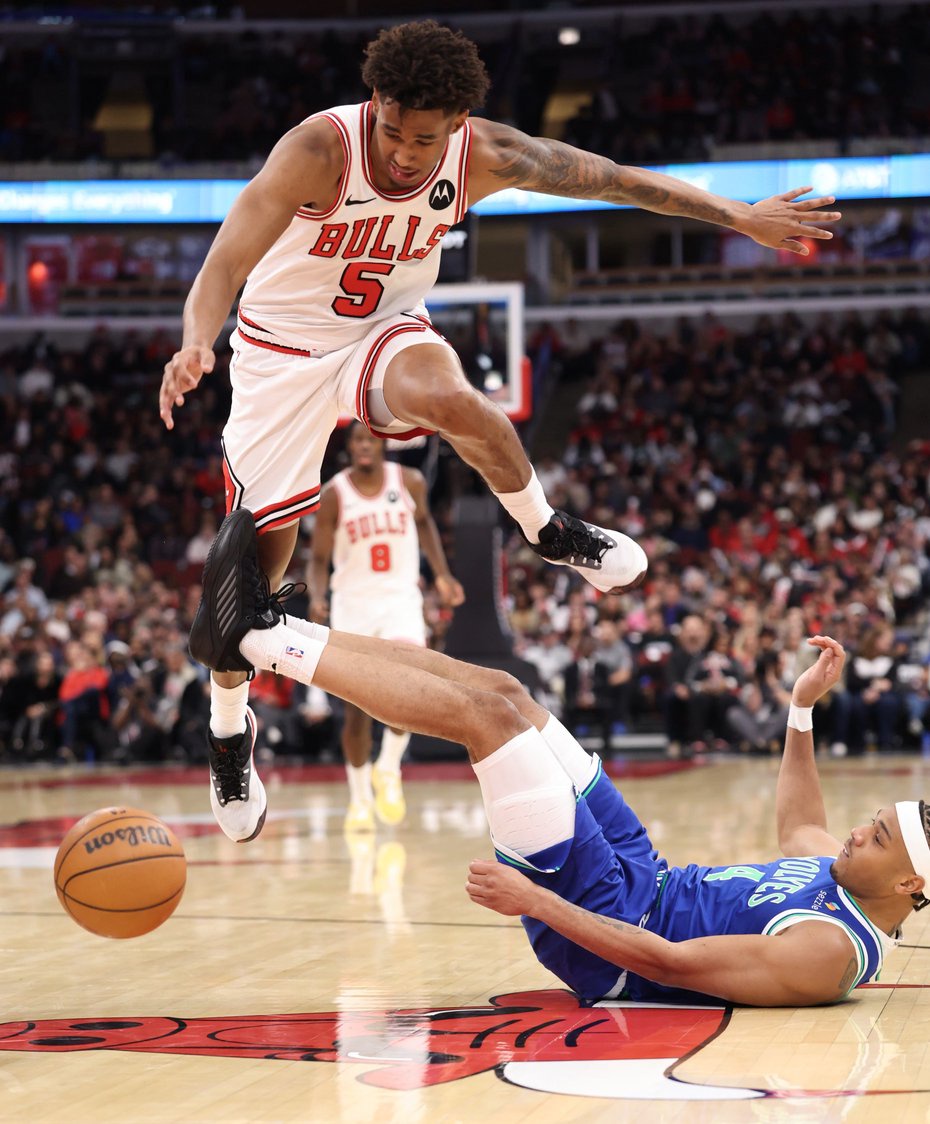 Bulls guard Dailyn Swain (5) jumps over Timberwolves guard Terrence Shannon Jr. on a loose ball chase in the second quarter of a preseason game at the United Center on Oct. 16, 2026, in Chicago. (John J. Kim/Chicago Tribune)