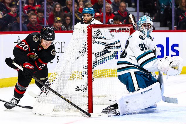 Ottawa Senators' Fabian Zetterlund (20) attempts a wraparound against San Jose Sharks goaltender Yaroslav Askarov (30) during the second period of an NHL hockey game in Ottawa, Ontario, Thursday, Oct. 22, 2026. (Keito Newman/The Canadian Press via AP)