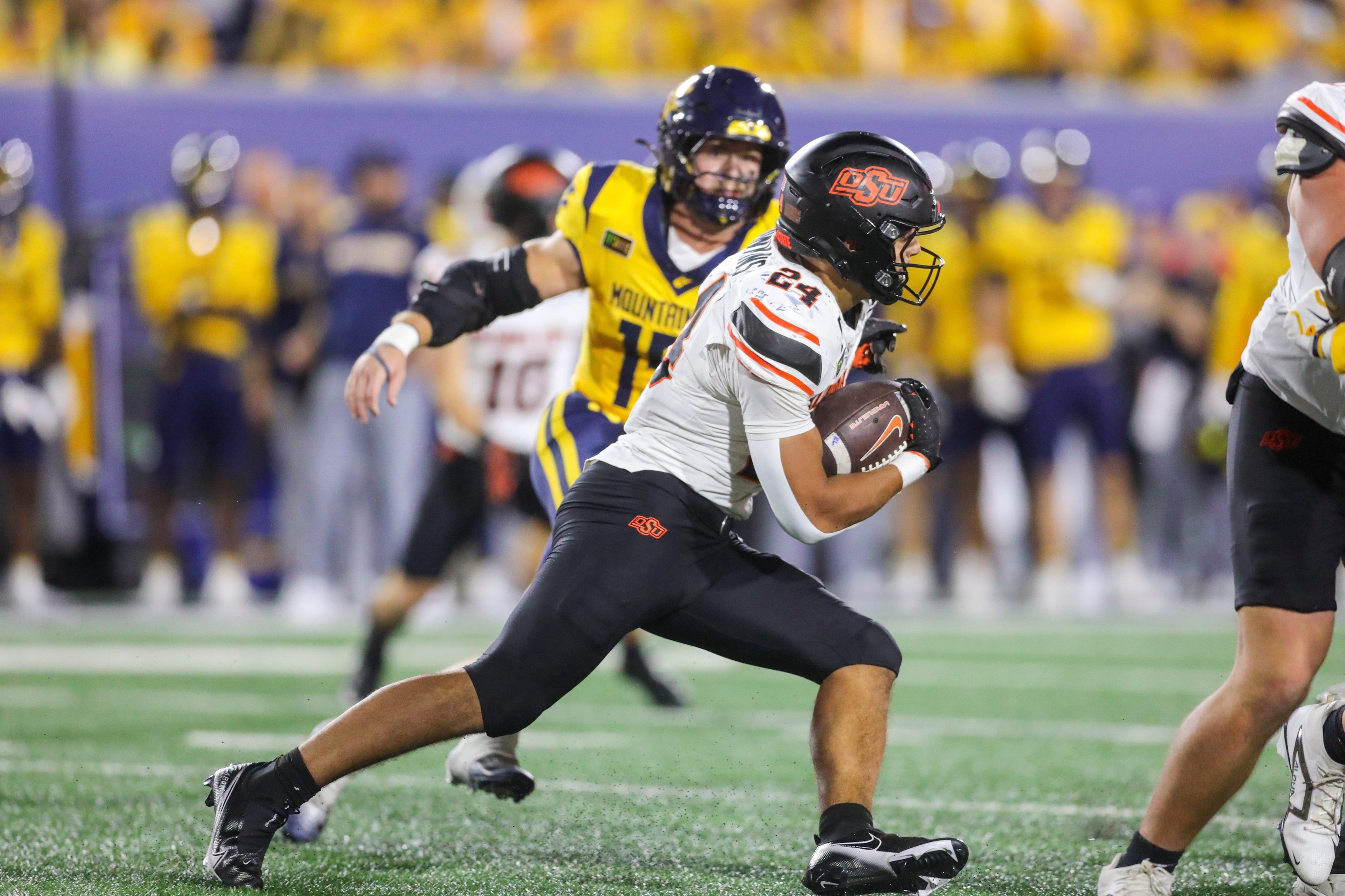Sep 26, 2026; Morgantown, West Virginia, USA; Oklahoma State Cowboys running back Caleb Hawkins (24) runs the ball during the fourth quarter against the West Virginia Mountaineers at Milan Puskar Stadium. Mandatory Credit: Ben Queen-Imagn Images