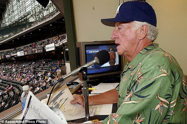 FILE - Milwaukee Brewers' radio announcer Bob Uecker works out of the radio booth during a baseball game against the Pittsburgh Pirates, July 7, 2003, at Miller Park in Milwaukee. (AP Photo/Morry Gash, File)