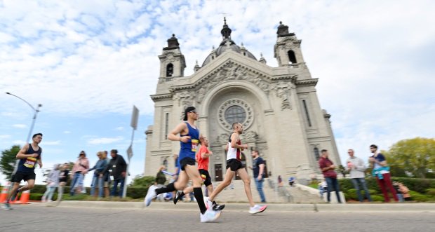 Runners pass the Cathedral of St. Paul.