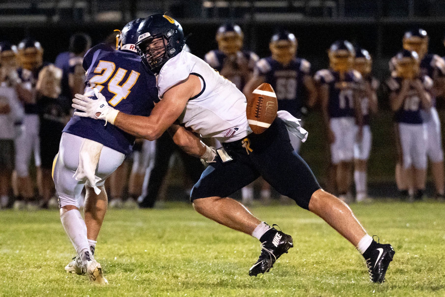 Regina’s Tate Wallace (0) tackles Alburnett’s Laken Caves (24) as the ball is passed toward them during a high school football game Sept. 10, 2026 in Alburnett, Iowa.