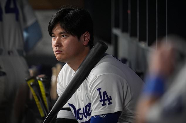 Los Angeles Dodgers designated hitter Shohei Ohtani watches from the dugout during the ninth inning of Game 4 of baseball's National League Championship Series between the Milwaukee Brewers and the Los Angeles Dodgers, Thursday, Oct. 15, 2026, in Los Angeles. (AP Photo/Gregory Bull)