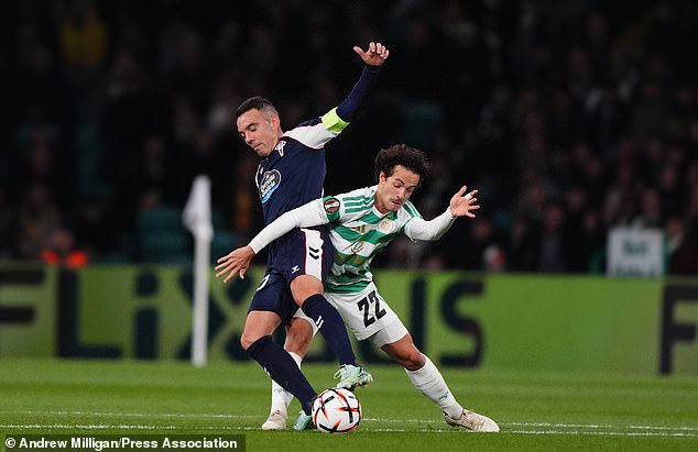Baur tussles with Celta captain Iago Aspas in the defeat at Parkhead on Thursday night