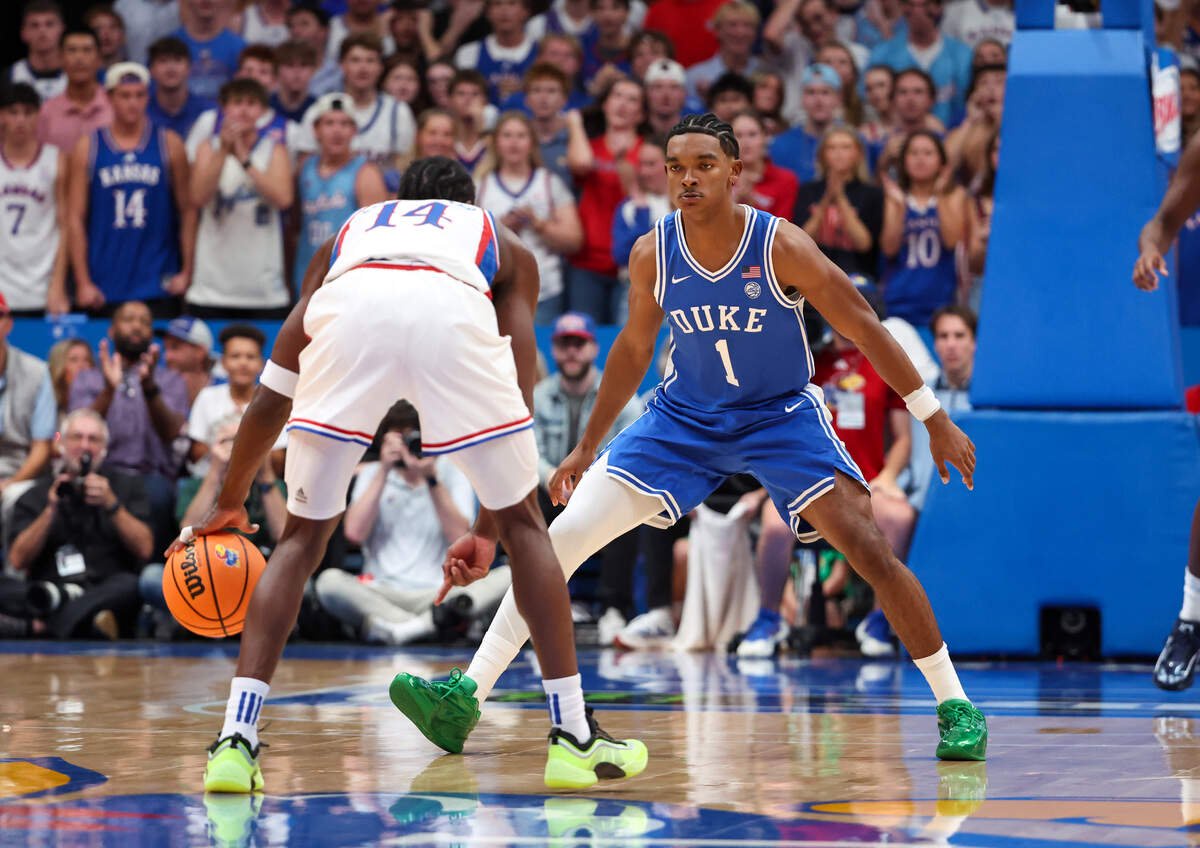 Oct 25, 2026; Lawrence, Kansas, USA;  Duke Blue Devils guard Caleb Foster (1) defends Kansas Jayhawks guard Luke Barnett (14) during the first half at Allen Fieldhouse.  Mandatory Credit: Scott Sewell-Imagn Images