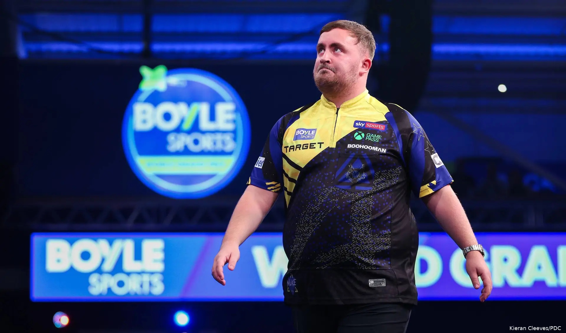 Luke Littler walks off stage in frustration.