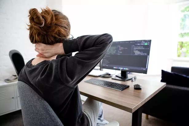 A photo of a woman with upper back pain