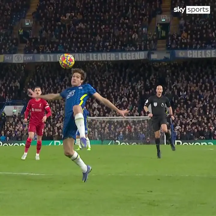 Both Marcos Alonso and ref Anthony Taylor have their eyes on the ball