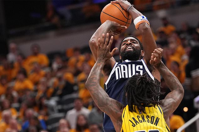 Dallas Mavericks guard Kyrie Irving, top, looks to shoot over Indiana Pacers guard Quenton Jackson, bottom, during the second half of an NBA basketball game in Indianapolis, Friday, Oct. 23, 2026. (AP Photo/AJ Mast)