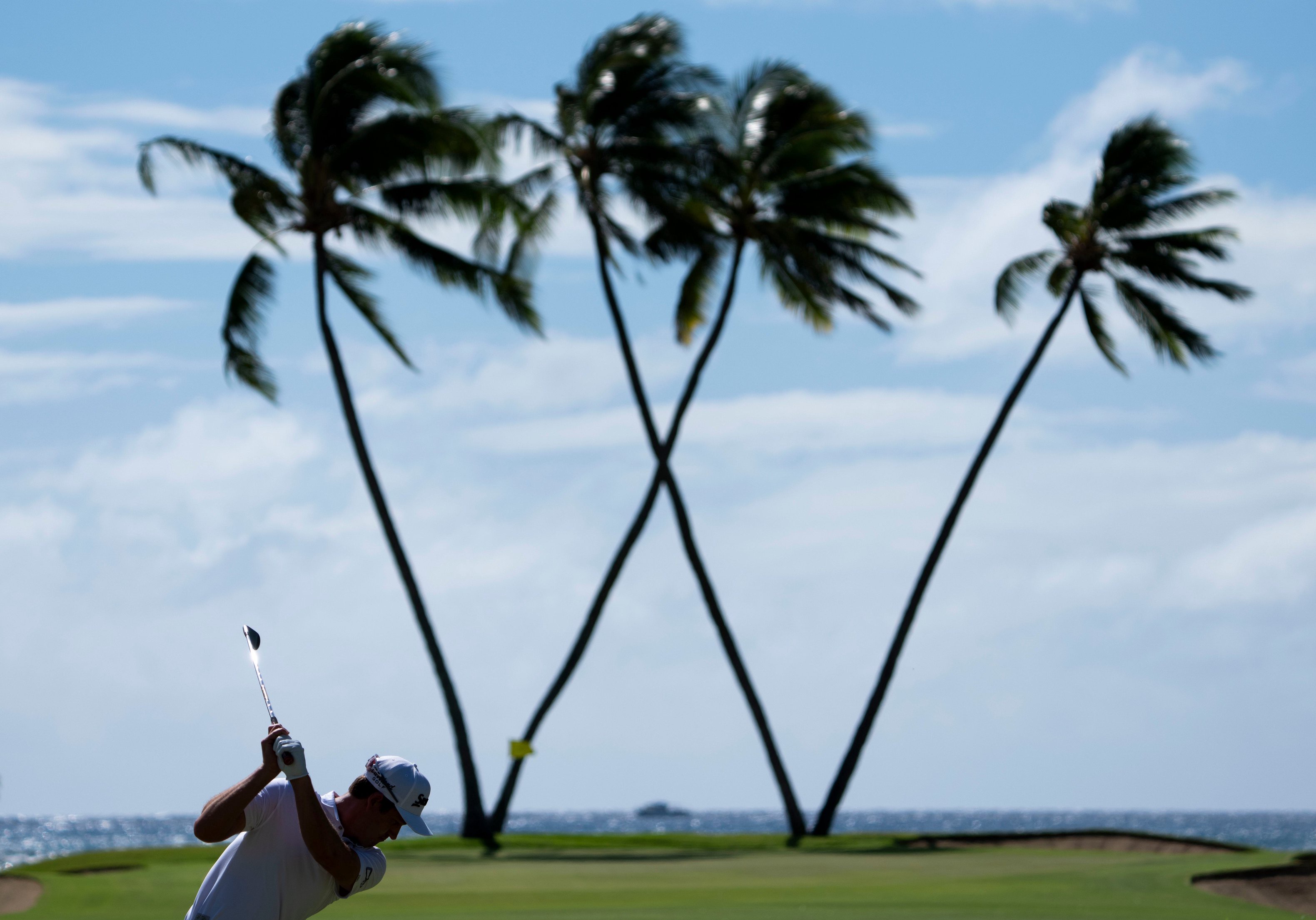 Andrew Putnam hits his second shot on the 16th hole during the final round of the Sony Open golf tournament at Waialae Country Club.
