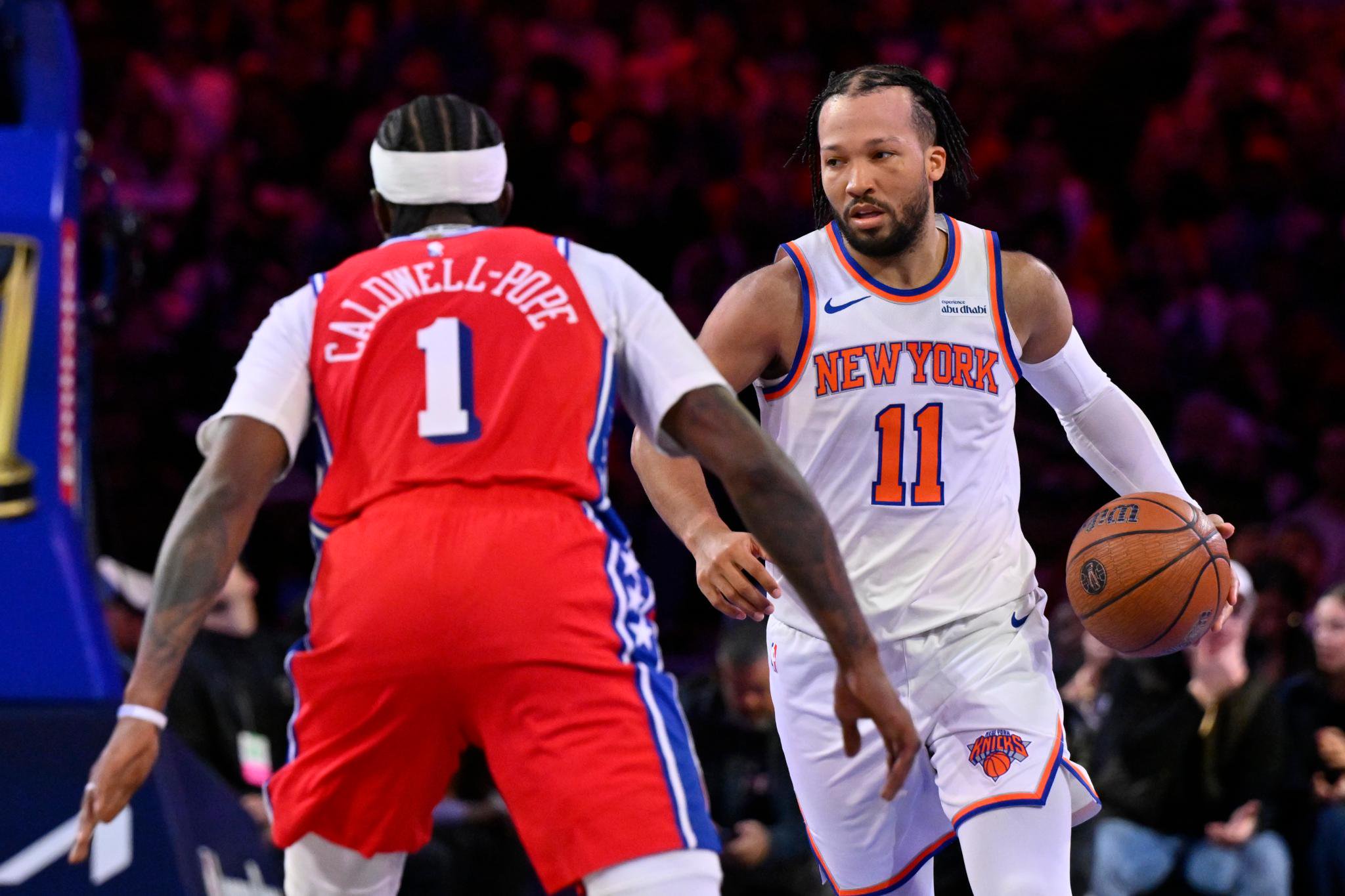 Jalen Brunson dribbles past Kentavious Caldwell-Pope during a game between the New York Knicks and Philadelphia 76ers.
