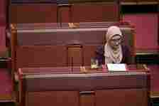 A woman in a headscarf sits in parliament