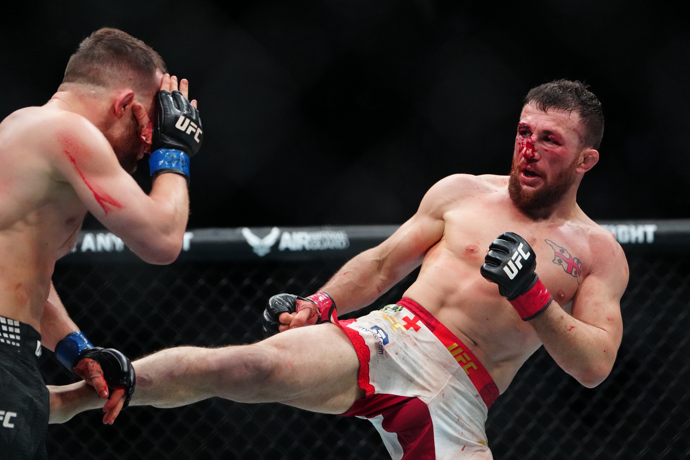 Dec 6, 2025; Las Vegas, Nevada, UNITED STATES; Merab Dvalishvili (red gloves) fights Petr Yan (blue gloves) during UFC 323 at T-Mobile Arena. Mandatory Credit: Stephen R. Sylvanie-Imagn Images