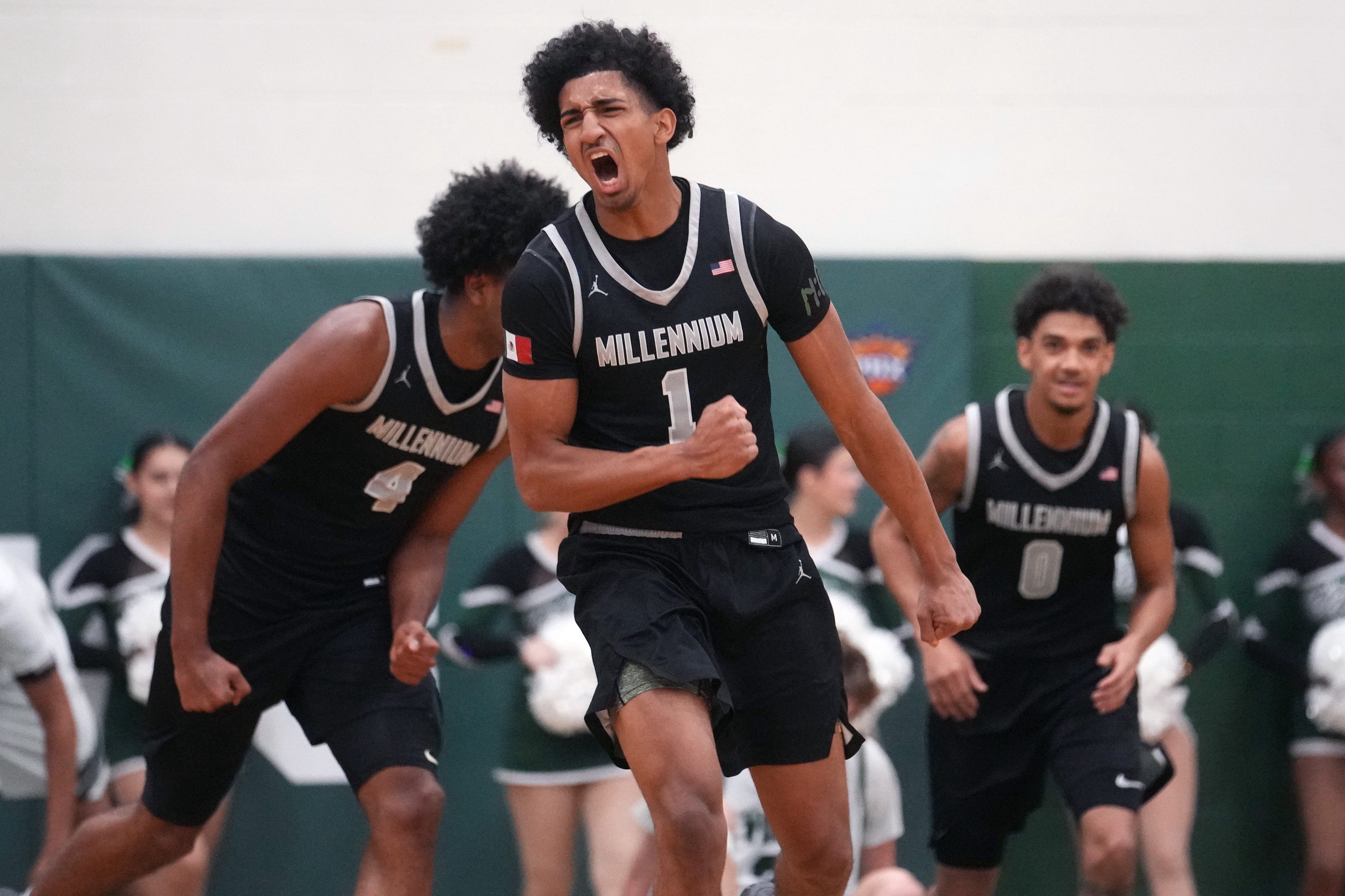 Millennium Tigers guard Adan Diggs (1) celebrates his dunk against the Sunnyslope Vikings during their game at Sunnyslope High School on Jan. 21, 2026.