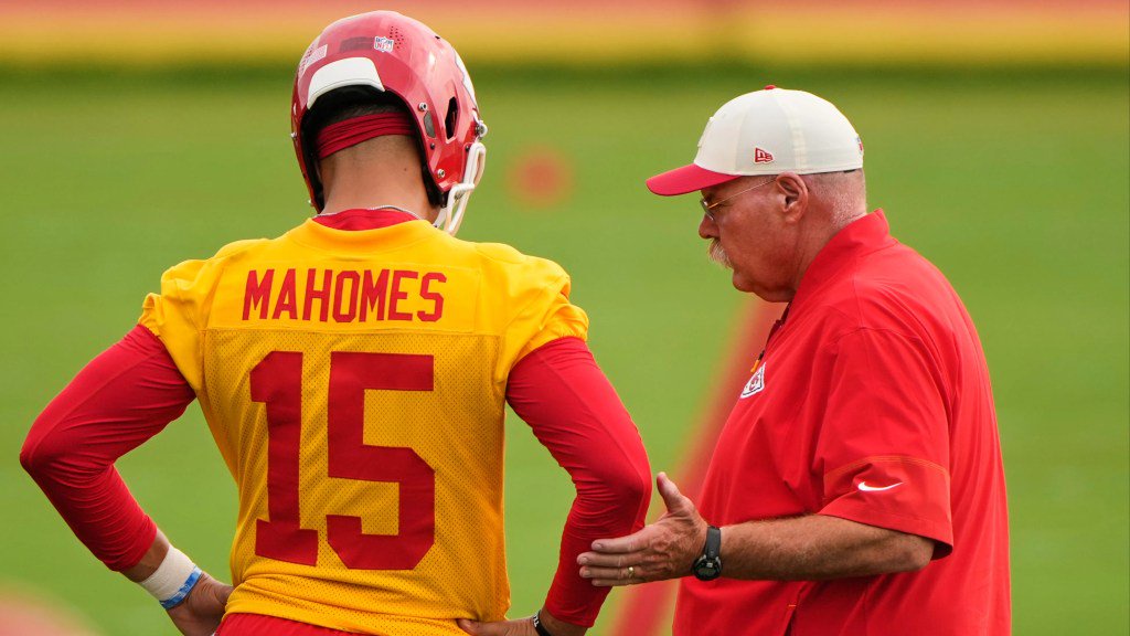 Kansas City Chiefs quarterback Patrick Mahomes (15) and head coach Andy Reid talk during NFL football training camp.