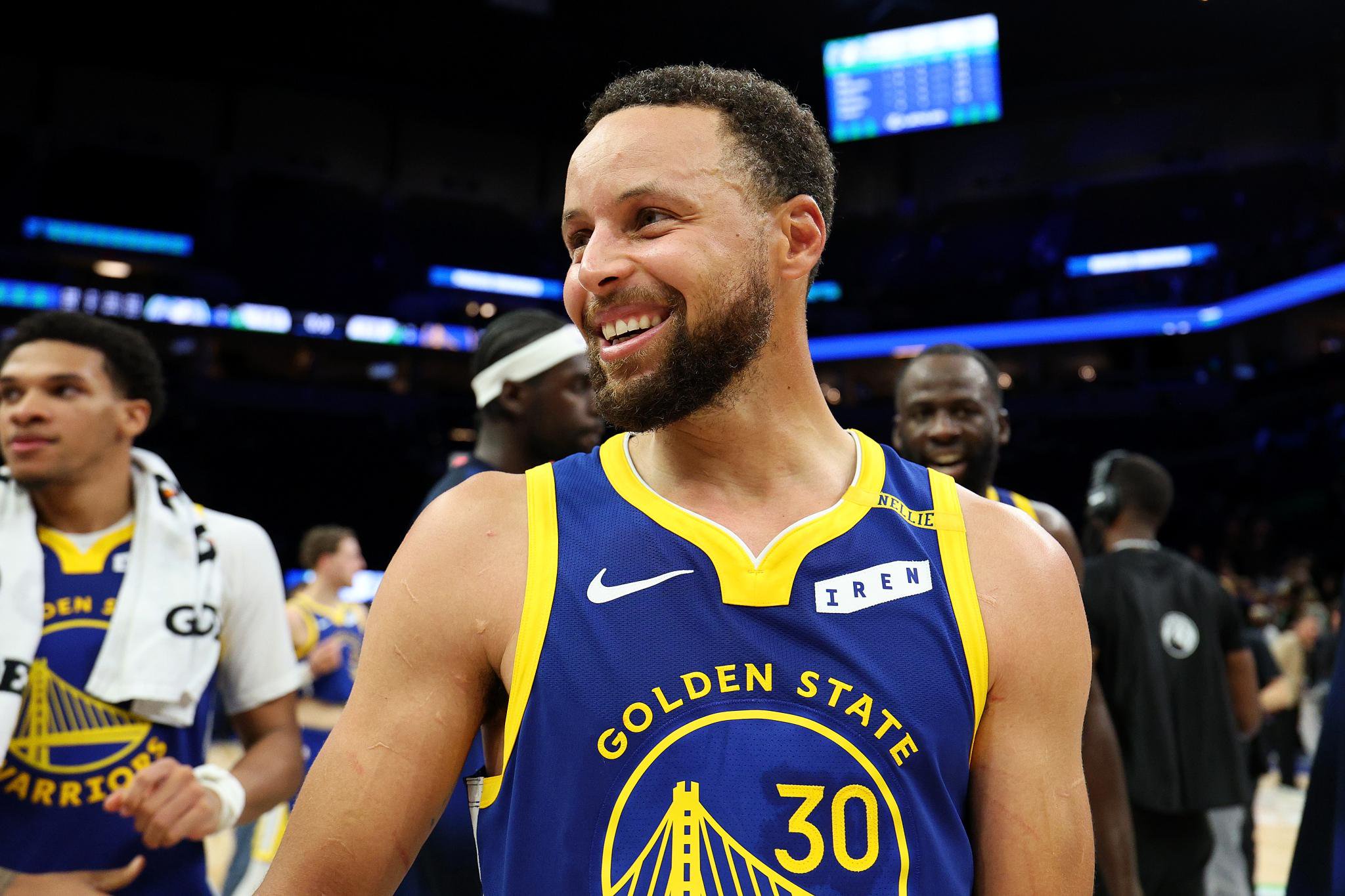 Stephen Curry of the Golden State Warriors smiling on the court.