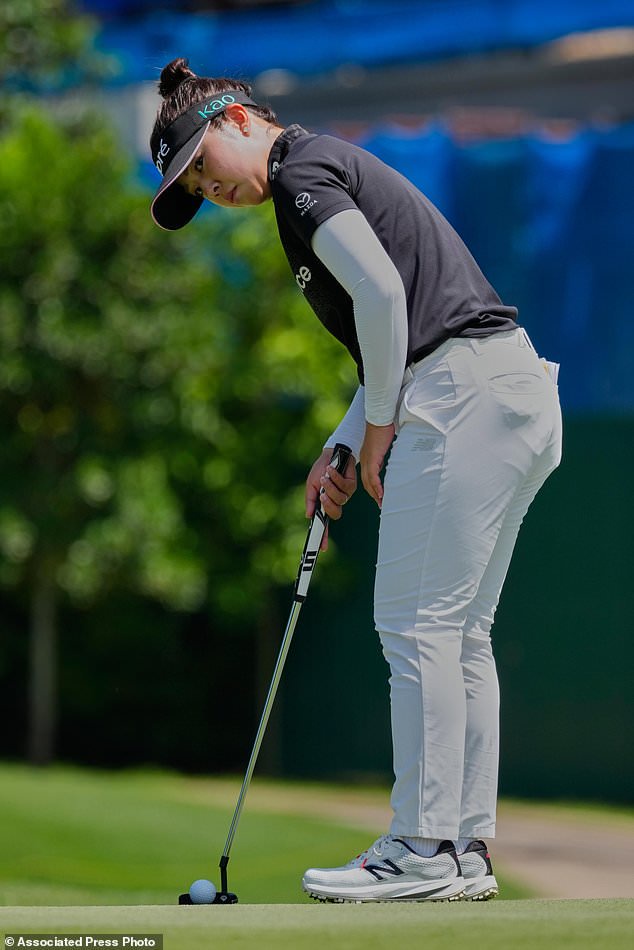 Miyu Yamashita of Japan watches a ball on the eighth hole during the second day of LPGA Maybank Championship in Kuala Lumpur, Malaysia, Friday, Oct. 30, 2026. (AP Photo/Vincent Thian)