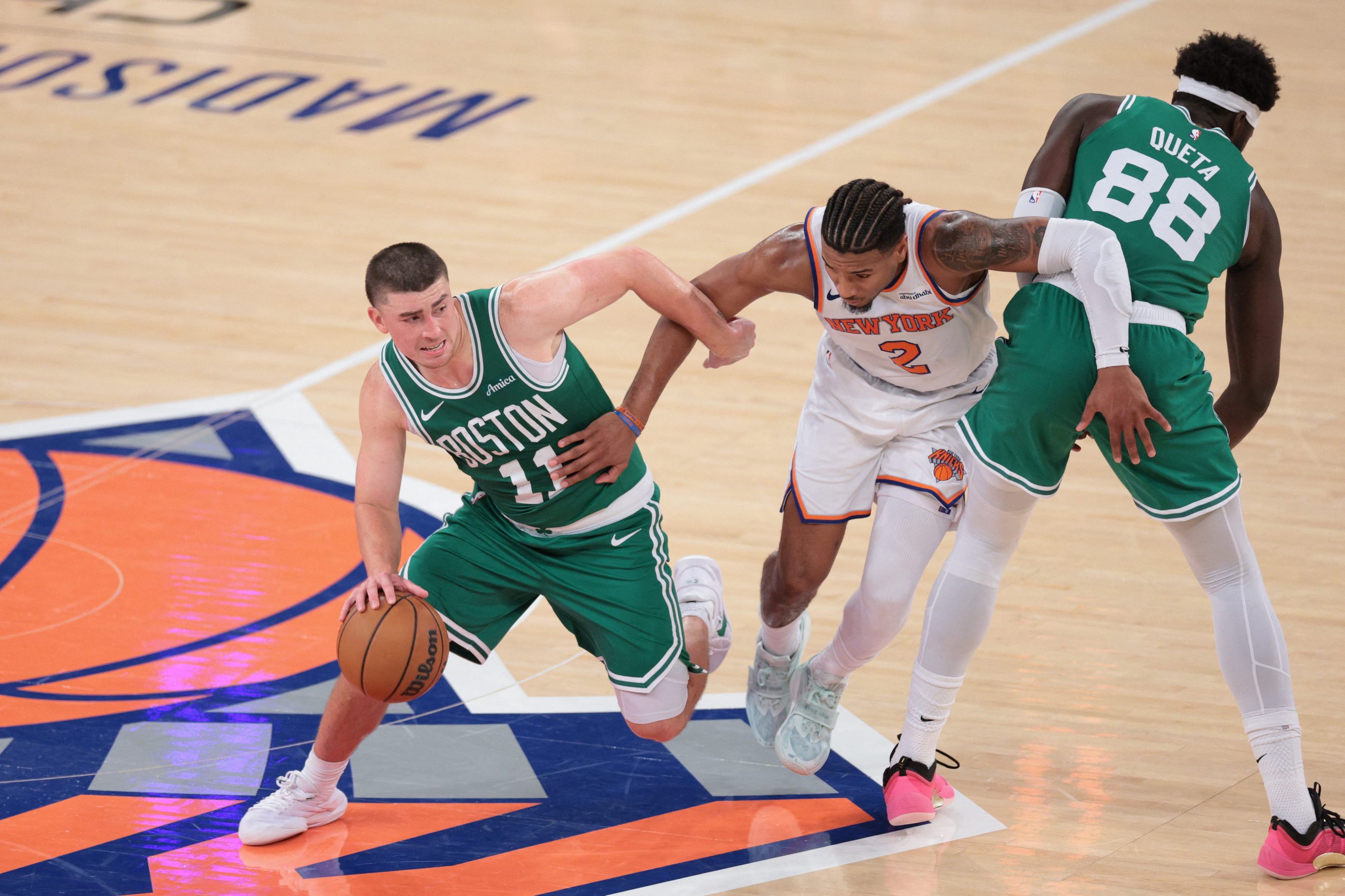 Oct 24, 2025; New York, New York, USA;  Boston Celtics guard Payton Pritchard (11) dribbles past New York Knicks guard Miles McBride (2) while center Neemias Queta (88) screens during the fourth quarter at Madison Square Garden. Mandatory Credit: Vincent Carchietta-Imagn Images