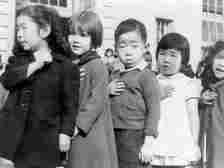 First-graders, some of Japanese ancestry, at the Weill public school, San Francisco, California, pledging allegiance to the United States flag.