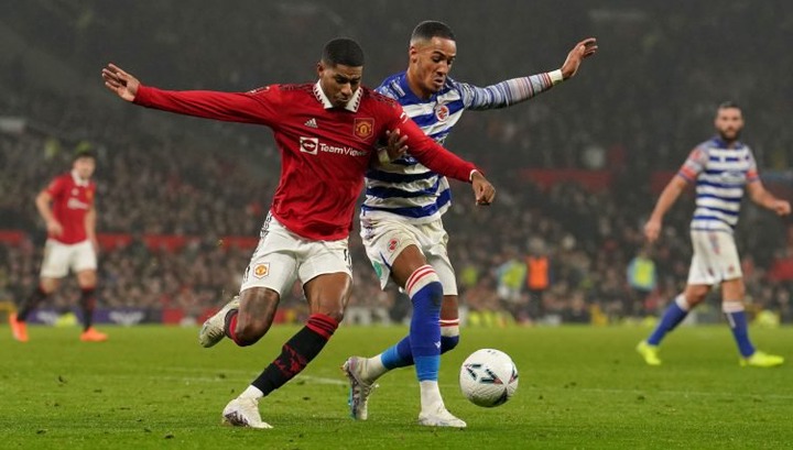 Manchester United's Marcus Rashford (left) and Reading's Thomas Ince battle for the ball during the Emirates FA Cup fourth round match at Old Trafford, Manchester. Picture date: Saturday January 28, 2023.