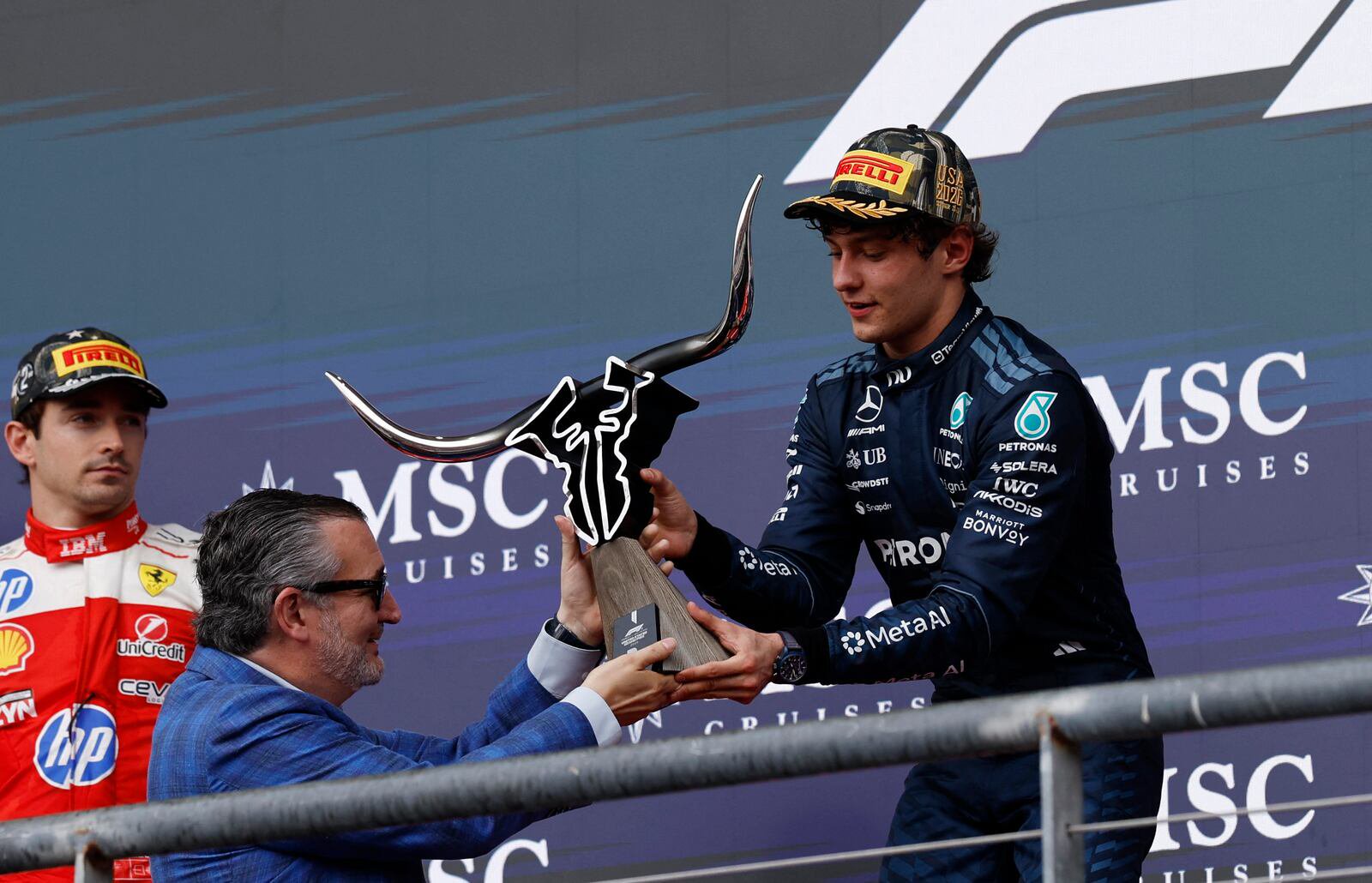 Formula One F1 - United States Grand Prix - Circuit of the Americas, Austin, Texas, U.S. - October 25, 2026 Mercedes' Andrea Kimi Antonelli is presented the trophy by United States Senator Ted Cruz on the podium after winning the United States Grand Prix