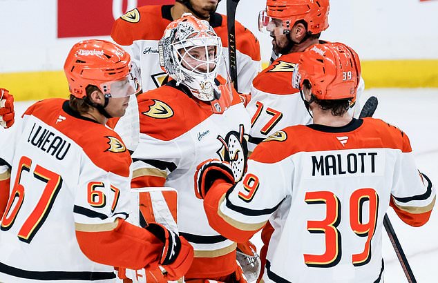 Anaheim Ducks goaltender Lukas Dostal, center, celebrates after his team defeated the Winnipeg Jets in of an NHL hockey game in Winnipeg, Manitoba, Friday, Oct. 9, 2026. (John Woods/The Canadian Press via AP)