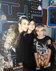 Kourtney Kardashian posing with Penelope and Reign Disick