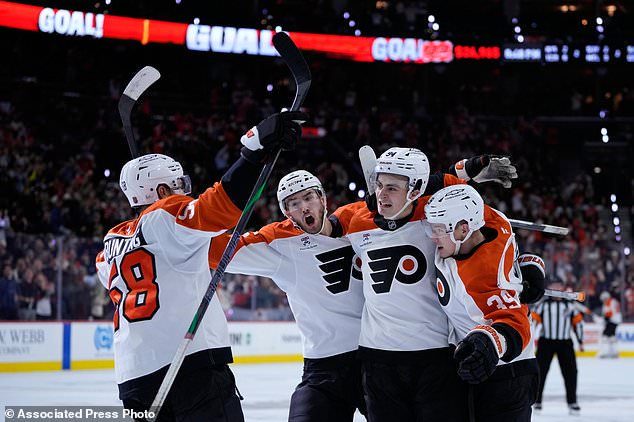 Philadelphia Flyers' Matvei Michkov, from right, Porter Martone, David Jiricek, and Michael Bunting celebrate after Michkov's goal during the second period of an NHL hockey game against the Ottawa Senators Saturday, Oct. 17, 2026, in Philadelphia. (AP Photo/Matt Slocum)
