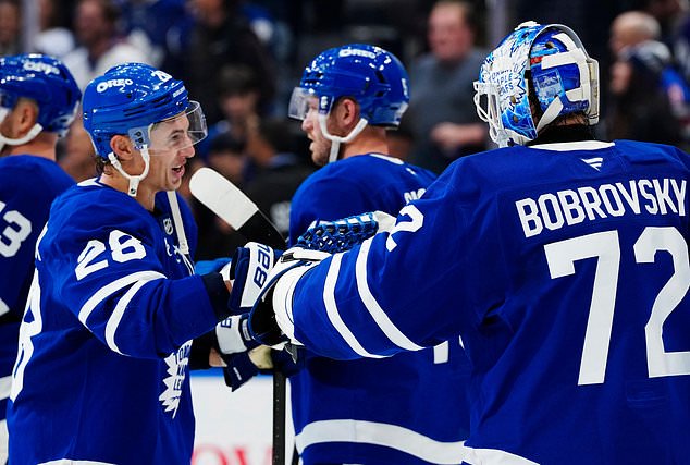 Toronto Maple Leafs' Troy Stecher (28) and goaltender Sergei Bobrovsky (72) celebrate after their team defeated the New York Rangers in an NHL hockey game in Toronto, Thursday, Oct. 22, 2026. (Frank Gunn/The Canadian Press via AP)