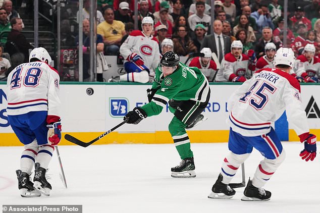 Dallas Stars defenseman Miro Heiskanen (4) has his shot blocked by Montréal Canadiens' Lane Hutson (48) as Alexandre Carrier (45) helps defend on the play in the first period of an NHL hockey game in Dallas, Thursday Oct. 29, 2026. (AP Photo/Tony Gutierrez)