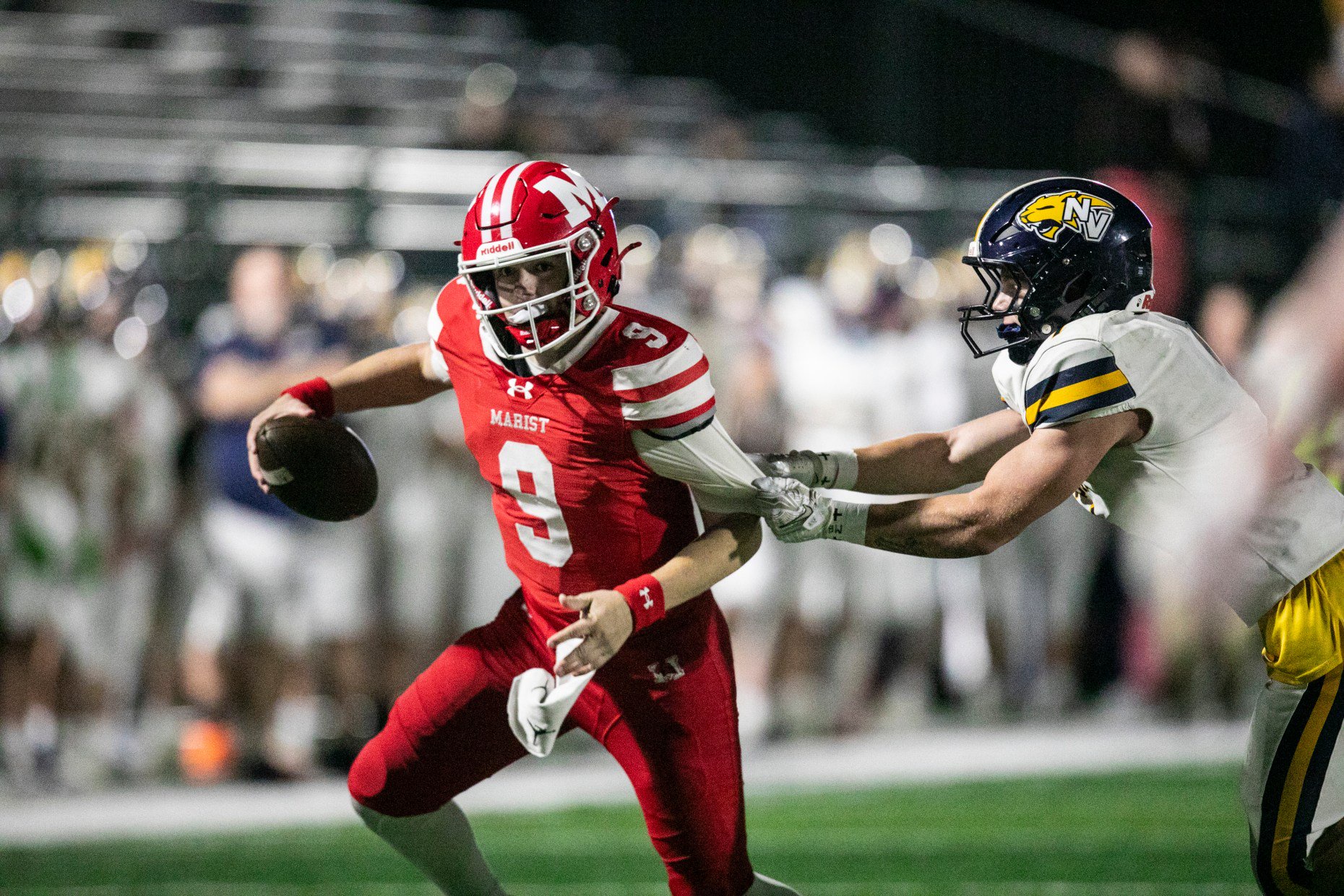 Maristâs Jake Fleming (9) scrambles out of the pocket as...